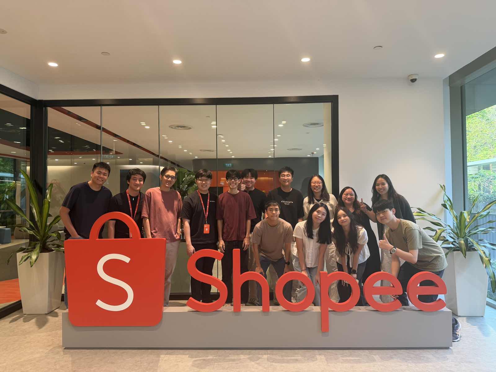 Vigo with the team in front of the Shopee sign