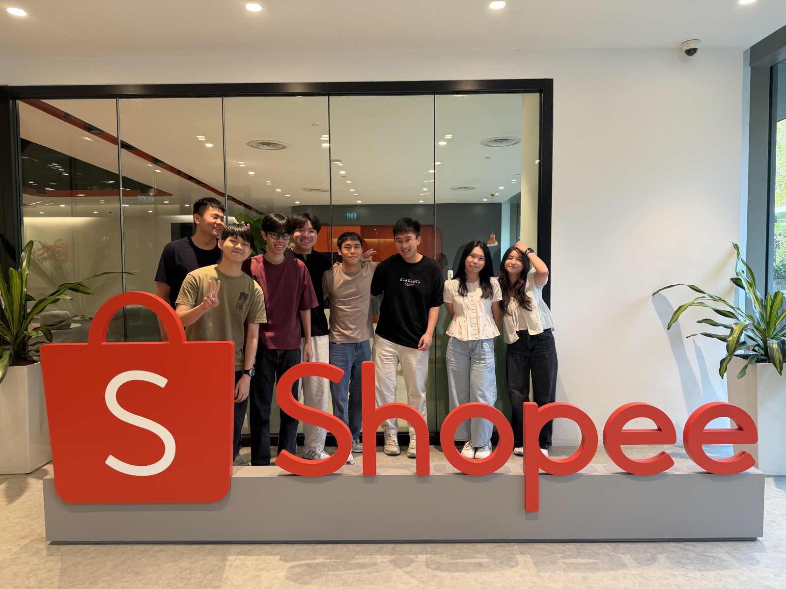 Vigo with teammates in front of the Shopee sign